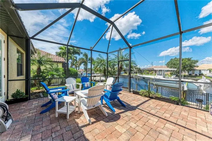 View of patio / terrace featuring a lanai and a water view