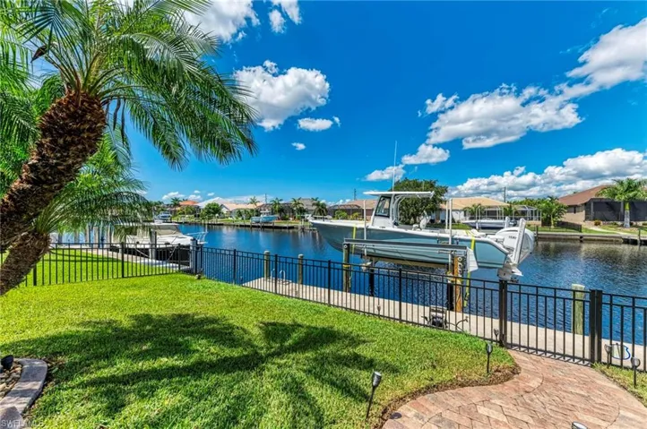 Dock area featuring a water view and a lawn