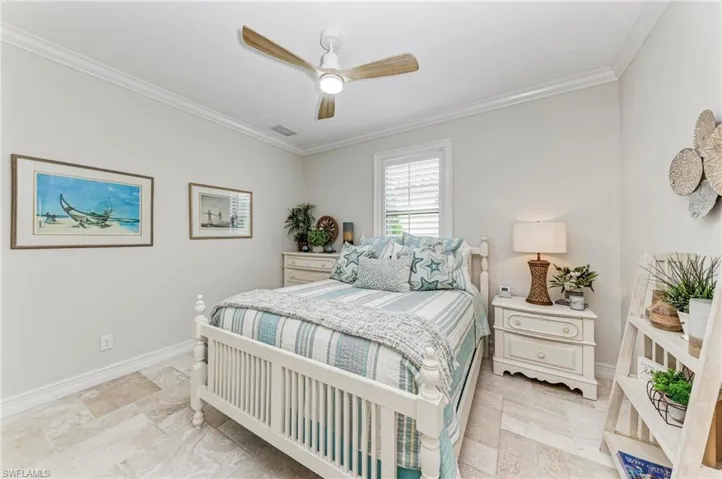 Bedroom featuring ceiling fan and ornamental molding