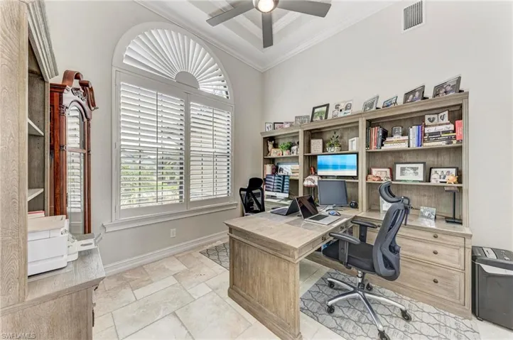 Office area featuring ceiling fan and crown molding