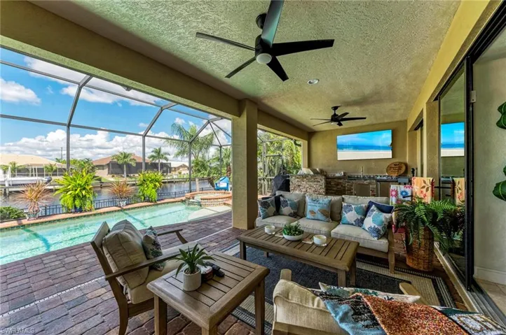 Sunroom / solarium with ceiling fan and a swimming pool