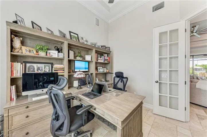 Office featuring ornamental molding, french doors, a towering ceiling, and ceiling fan