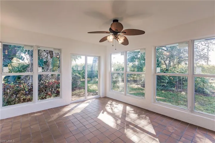 Unfurnished sunroom with tile patterned floors