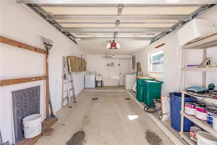 Garage with a garage door opener and independent washer and dryer