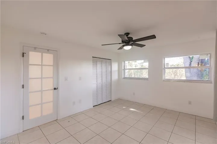 Spare room featuring a ceiling fan and light tile patterned floors