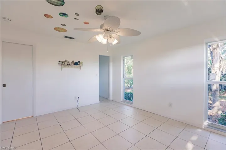 Spare room featuring ceiling fan and light tile patterned flooring