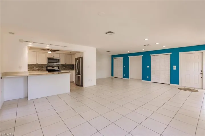 Unfurnished living room featuring recessed lighting, a ceiling fan, and light tile patterned floors