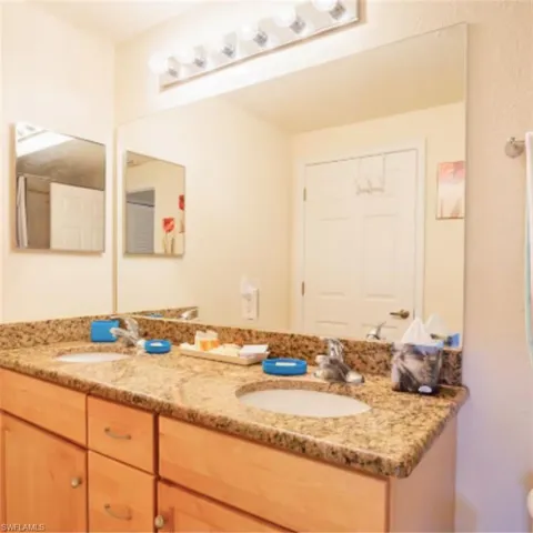 Double vanity featuring granite countertops and undermount sinks