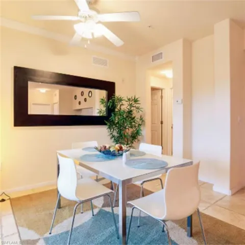 Ceiling fan with light kit, crown molding, cased doorway, recessed lighting, and tile flooring
