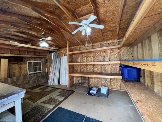 View of patio with a storage shed.