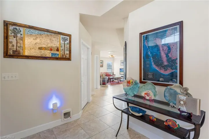 Hall featuring light tile patterned floors
