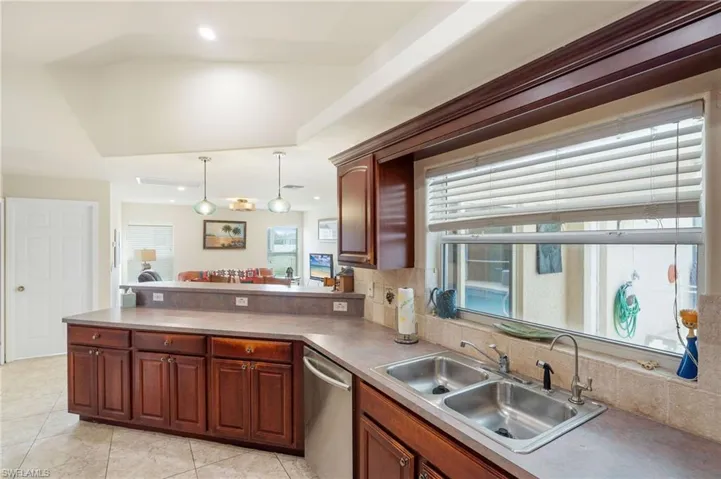 Kitchen featuring sink, plenty of natural light, decorative light fixtures, and dishwasher
