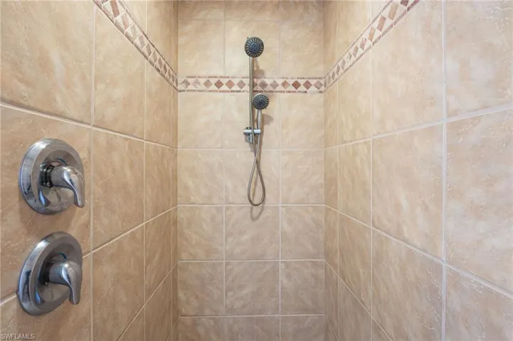 Room details featuring a tile shower