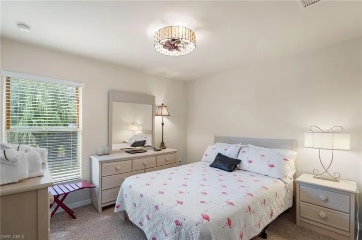 Bedroom with multiple windows and carpet