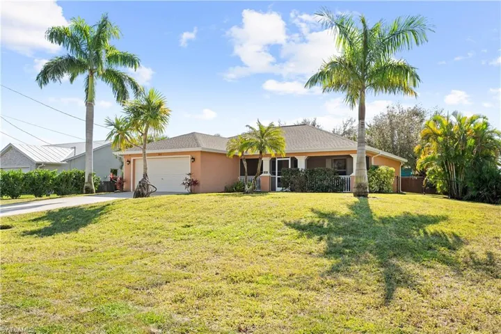 Ranch-style home with concrete driveway, stucco siding, and an attached garage