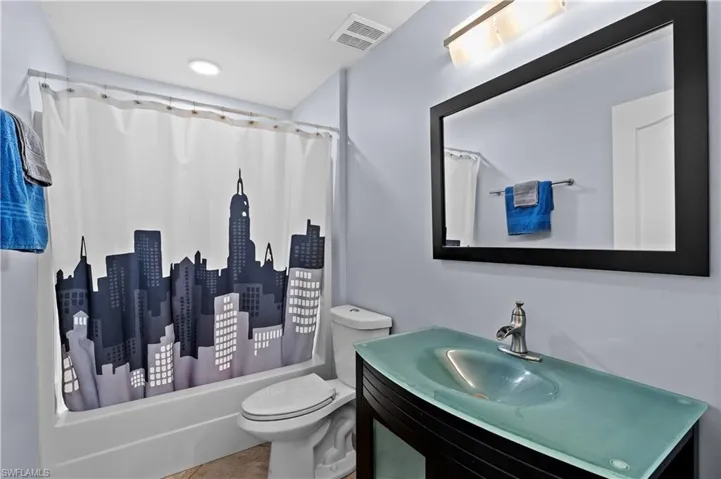 Full bath with vanity and shower / bath combination with curtain