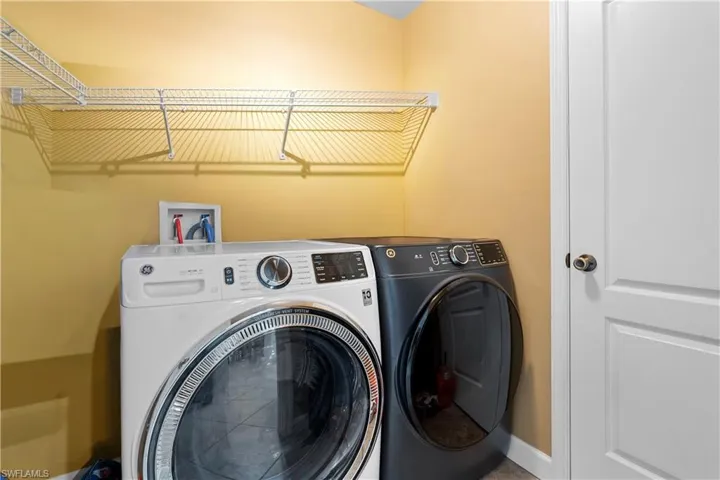 Washroom with washing machine and clothes dryer