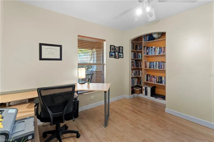 Office area featuring light wood-style floors and a ceiling fan