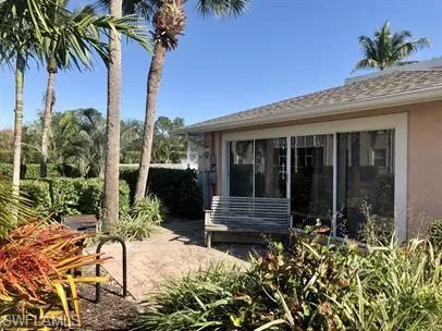 View of patio with a sunroom