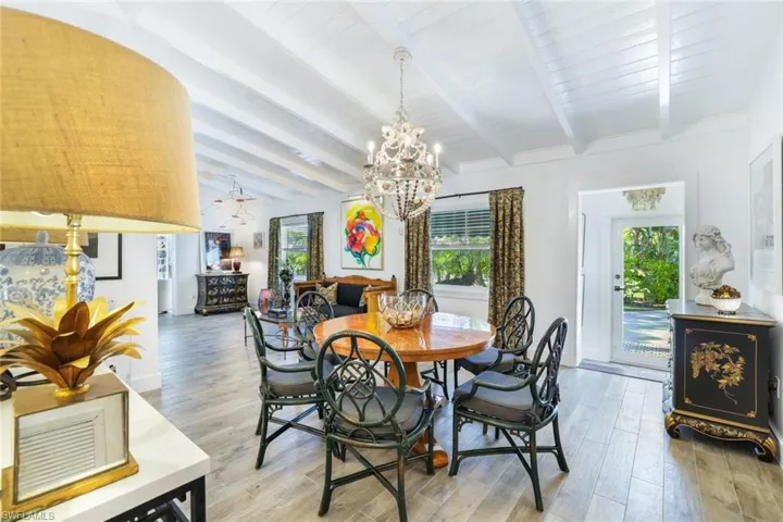Room off of kitchen is a combination den/family room and dining space. Wood look tile flooringNew impact resistant windows and doors throughout the home