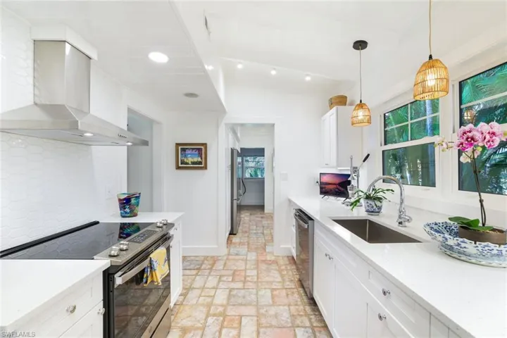 Kitchen view to walk in Butler's Pantry with additional two wall ovens and two refrigerators.