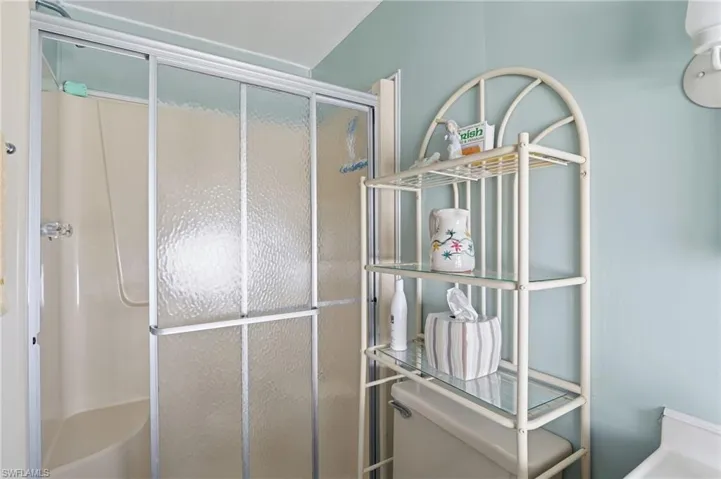 Full bathroom featuring a shower stall