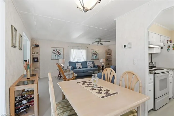 Dining area featuring crown molding and ceiling fan