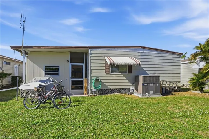 Rear view of property with a yard