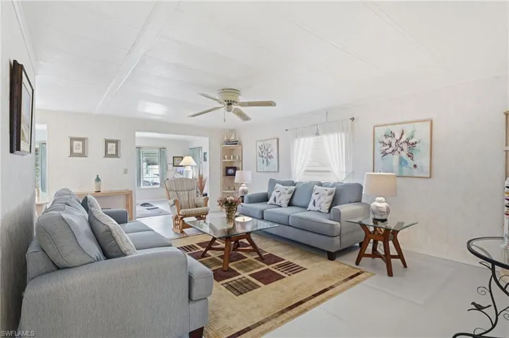 Living area featuring a ceiling fan, with lots of natural light