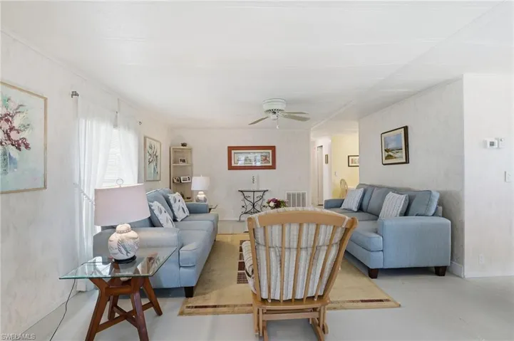 Living room with baseboards and a ceiling fan
