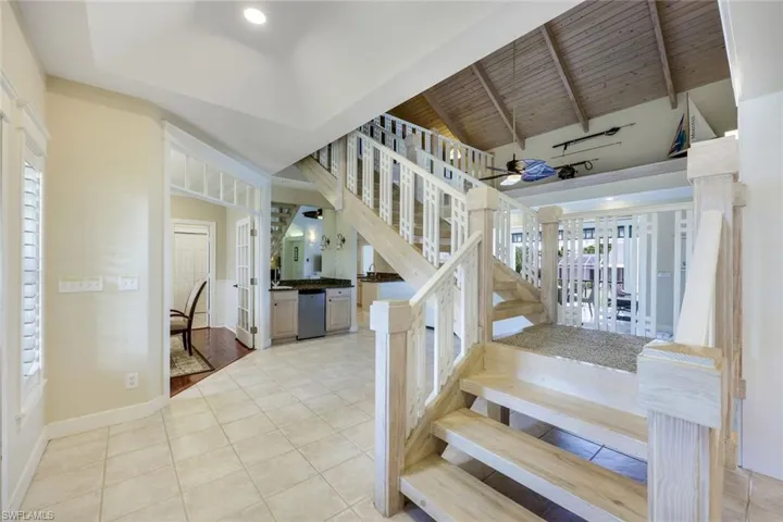 Entryway features a grand staircase and canal views.