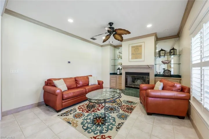 Formal sitting area features a wood-burning fireplace.