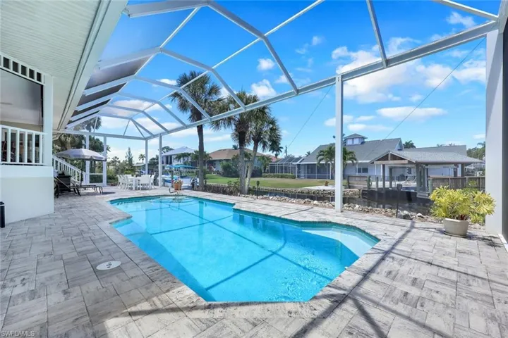 Swim day or night, this home offers so much outdoor space to entertain and a canal view!