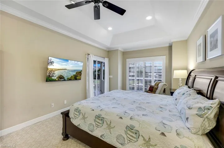 Large primary bedroom with canal views and lanai access.