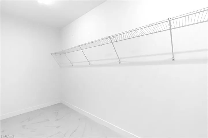 Spacious closet with marble finish floor