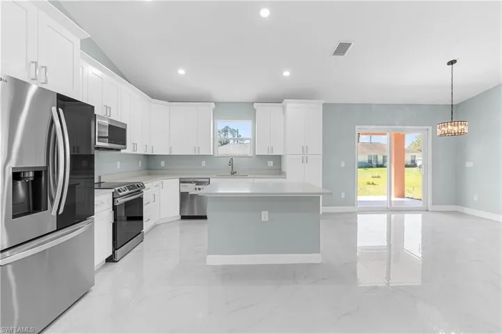 Kitchen with a sink, a healthy amount of sunlight, visible vents, and stainless steel appliances