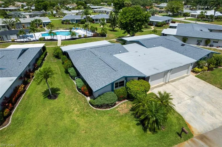 Aerial view of residential area featuring a pool area