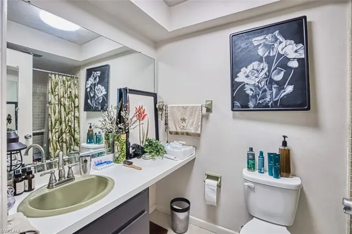 Full bath with vanity, a shower with shower curtain, and tile patterned flooring