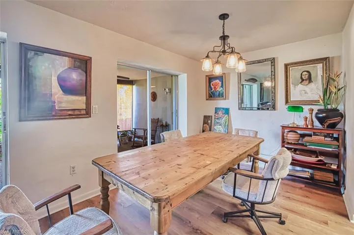 Dining area featuring light wood finished floors and a chandelier