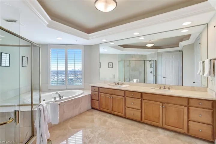 Primary Bathroom with double marble-top vanity