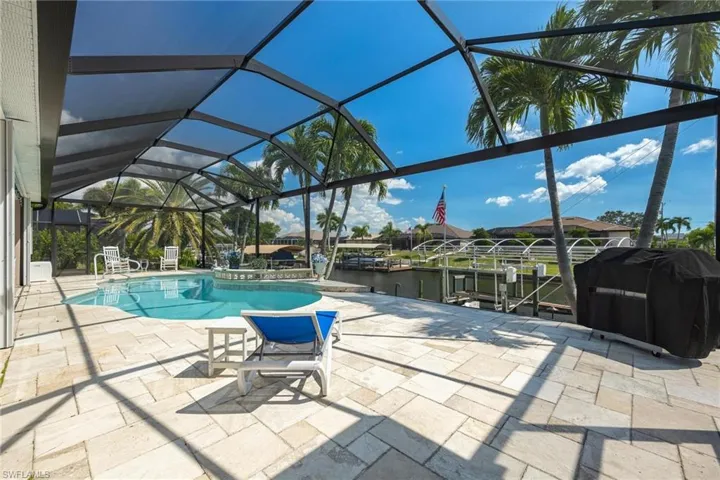 Gorgeous pool and lanai waterfront view from the guest bed sliders