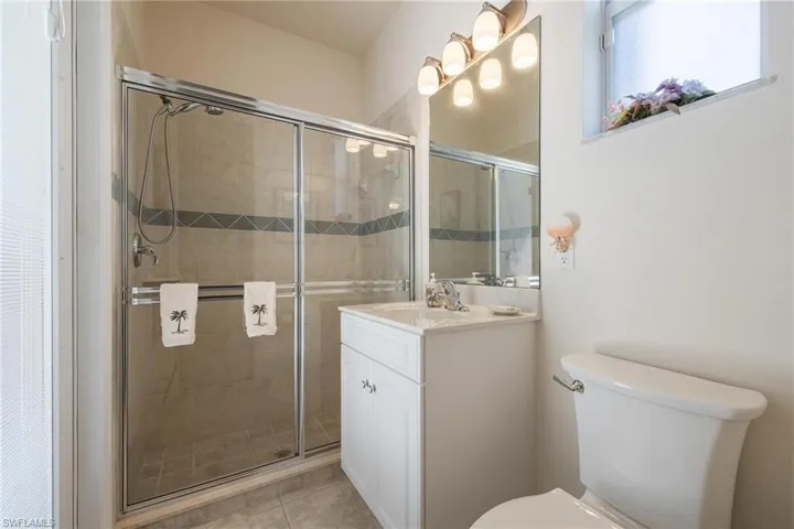 Ensuite bathroom with walk in shower and pool bath door.