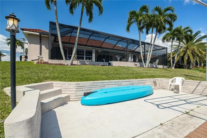 Lovely concrete dock with lighting and plenty of space for kayaks and tiki hut or patio seating!