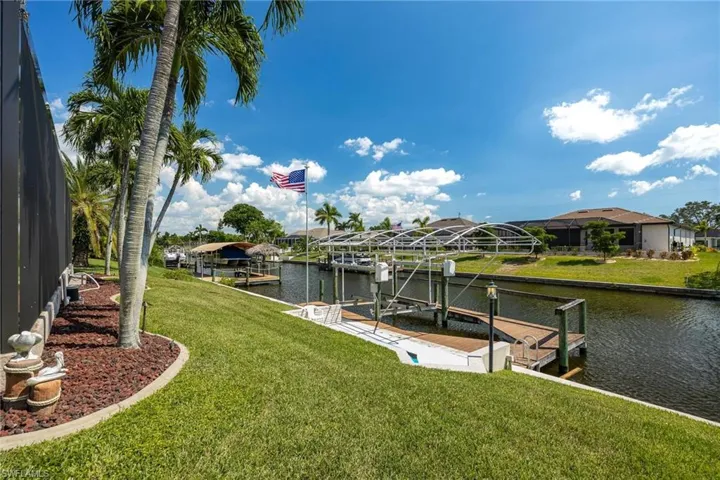 View of your dock space, boat and captain's walk from the lush, landscaped yard.