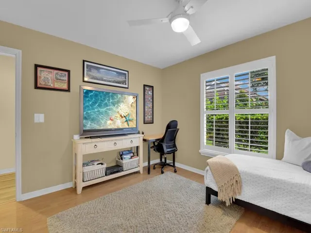 Bedroom featuring ceiling fan and hardwood / wood-style flooring