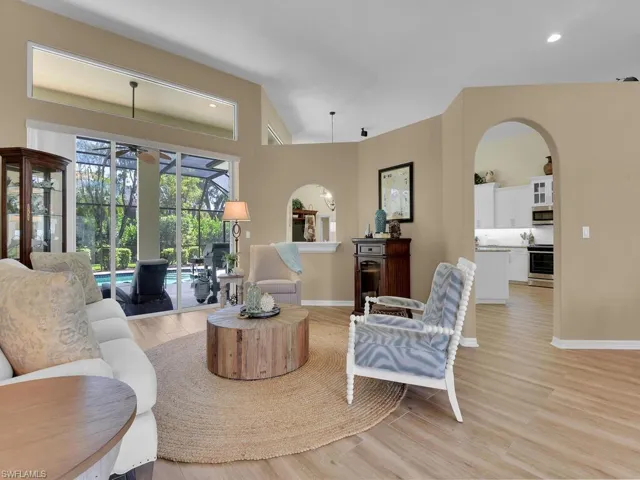 Living room featuring light wood-type flooring and lofted ceiling