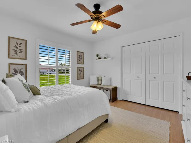 Bedroom featuring light wood-type flooring, ceiling fan, and a closet