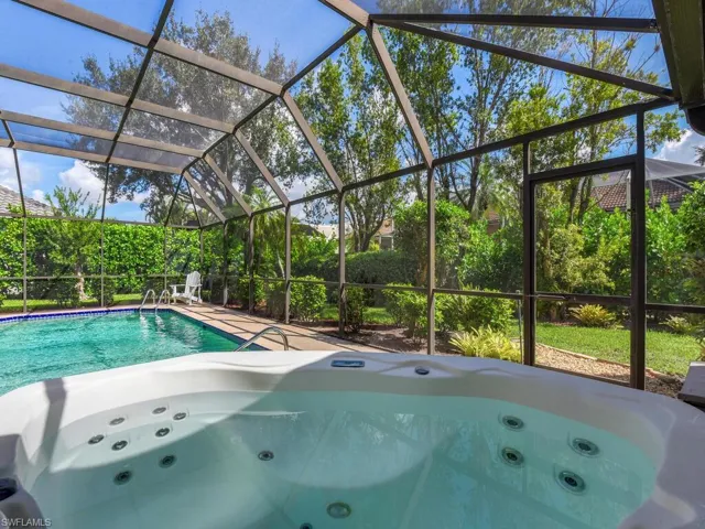 View of swimming pool with a jacuzzi, a lanai, and a patio area
