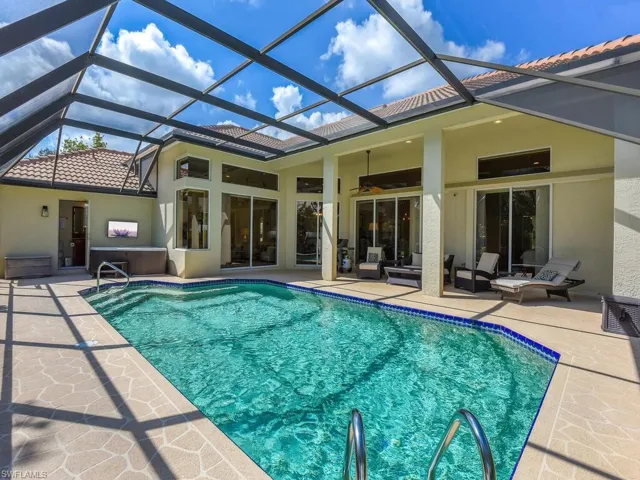 View of swimming pool with a lanai, a patio, and ceiling fan