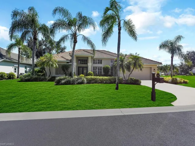 Mediterranean / spanish-style house with a front yard and a garage